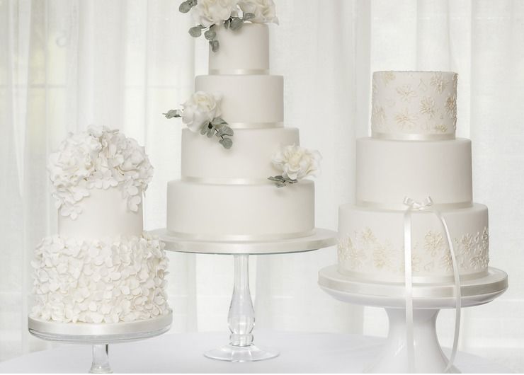 A trio of white wedding cakes