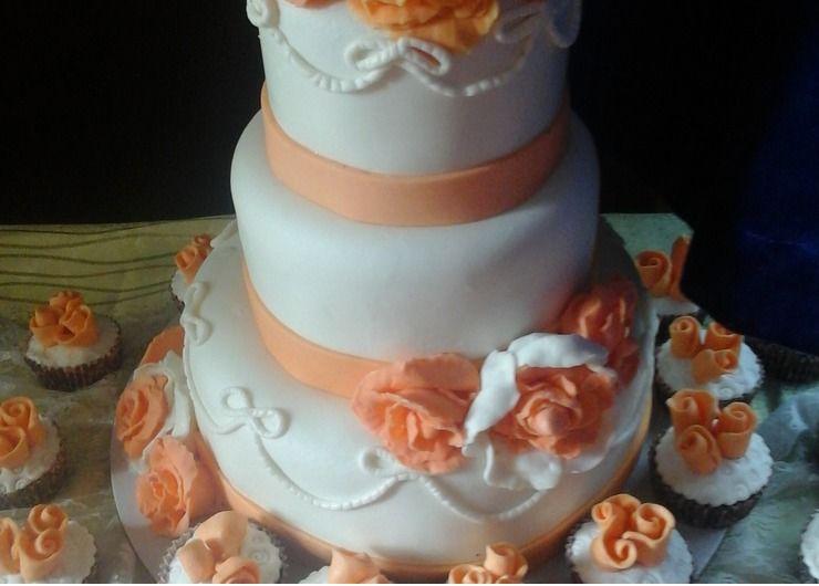 Peach and White Wedding Cake and cupcakes